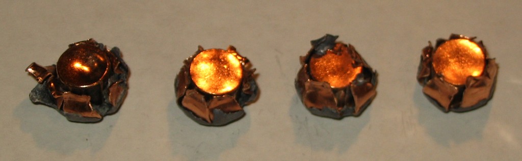 10mm_paper Four 10mm Auto 180gr Hornady XTP bullets recoved from the wet catalog testing. Weight,1) 161.0gr (89.4%); 2) 148.5gr (82.5%); 3) 146.7gr (81.5%); 4) 142.3gr (79.1%)